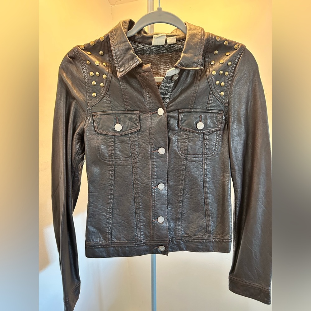 Faux Leather jacket with rivets applications .